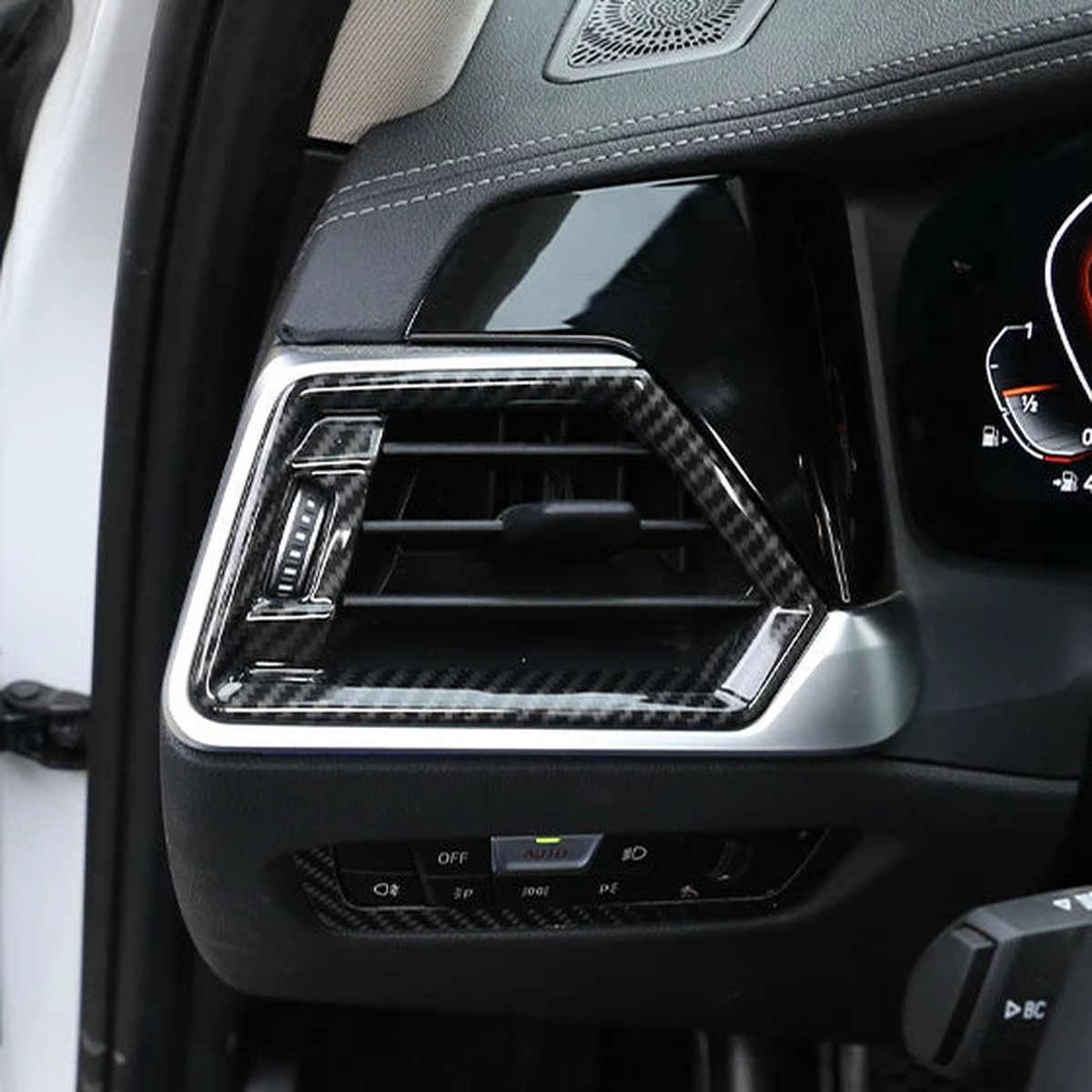 Carbon-look side air vent frame fitted on the driver's dashboard, in-car view, for BMW 3 Series G20 LHD 2020-2022