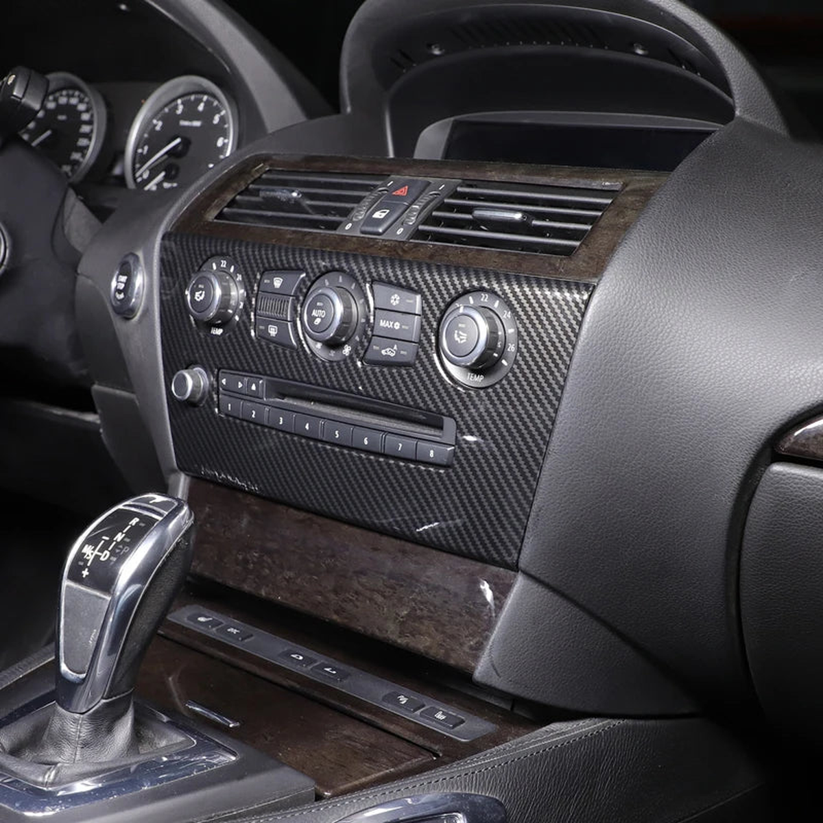 Carbon fiber center console and radio trim fitted in a BMW E63 / E64 interior