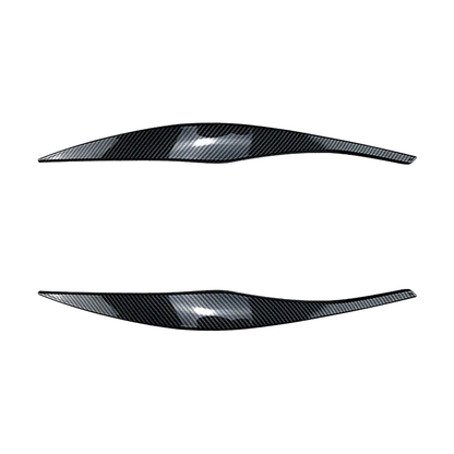 Carbon fiber look headlight eyebrow trim pair for BMW E90 / E91, front view