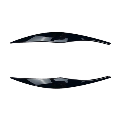 Gloss black headlight eyebrow trim pair for BMW E90 / E91, close view
