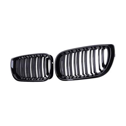 Gloss black double slat kidney grille pair, angled front view, for BMW E46 4-door 2002 to 2005