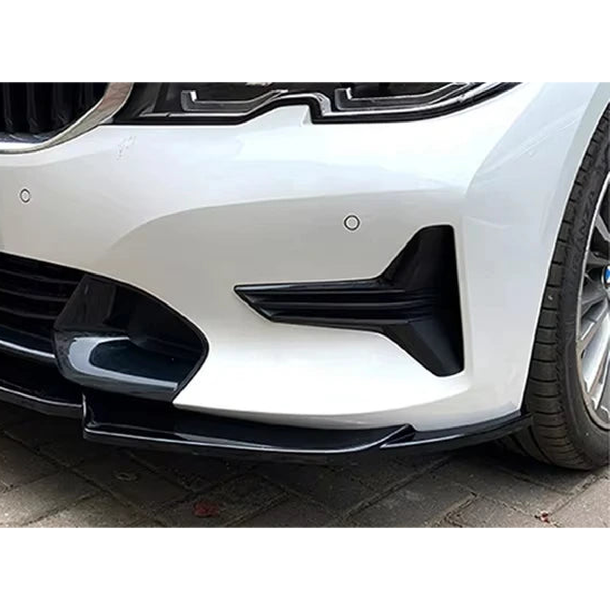 Gloss black front bumper lip fitted under the front bumper of a white BMW G20 / G21 non M Sport