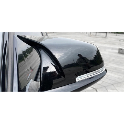 Gloss black mirror cap cover fitted on the door mirror of a BMW F20 / F30 / F32 / X1 E84