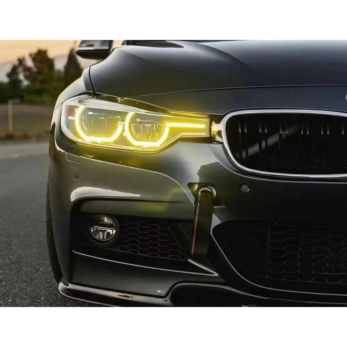 Yellow LED DRL angel eyes lit on a BMW front headlight for BMW F30, F31 LCI headlights (2016-2019)
