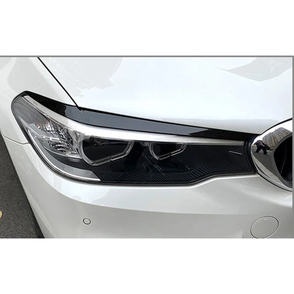 Gloss black headlight eyebrow trim fitted on a BMW 5 Series G30 / G31 / G38 / F90 M5 headlight