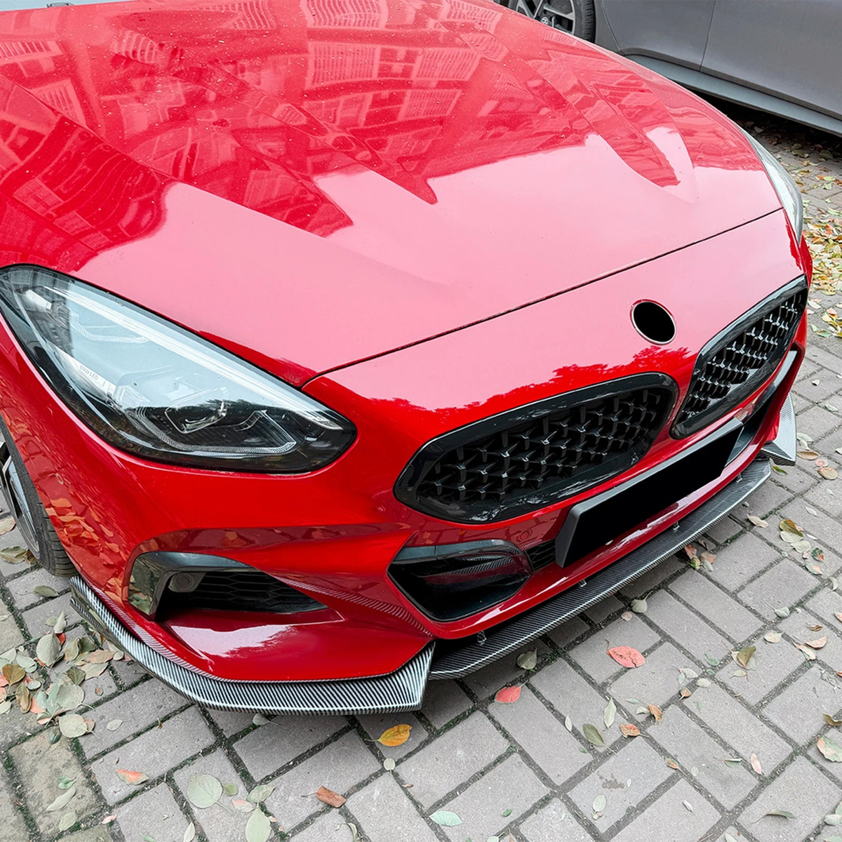 Carbon fiber look front lip splitter fitted to a red BMW Z4, for BMW Z4 G29 M Sport (2019-2022)