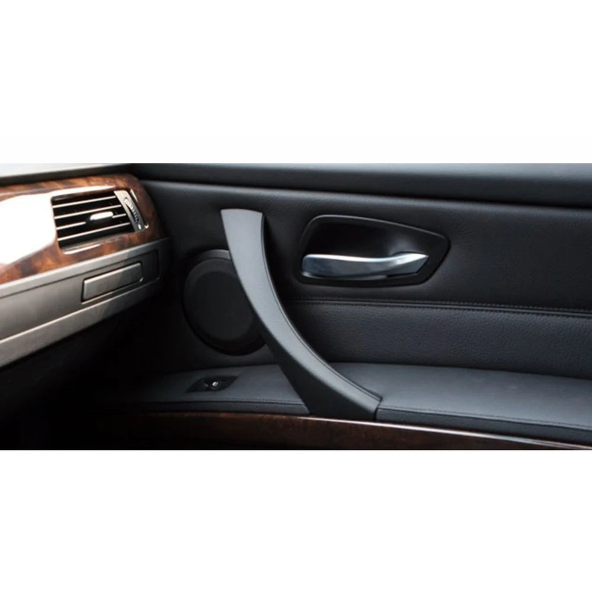 Black interior door pull handle cover installed on a BMW 3 Series E90 door panel (2005-2011)
