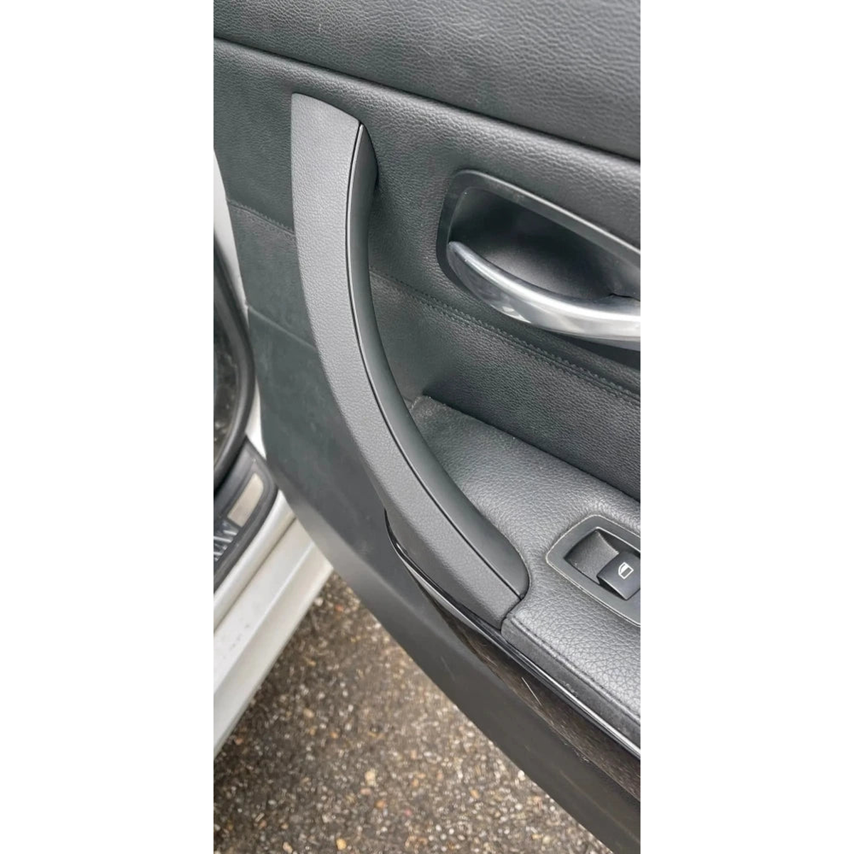Black door pull handle installed in a door panel, for BMW 3 Series E90, E91, E92 (2005-2012)